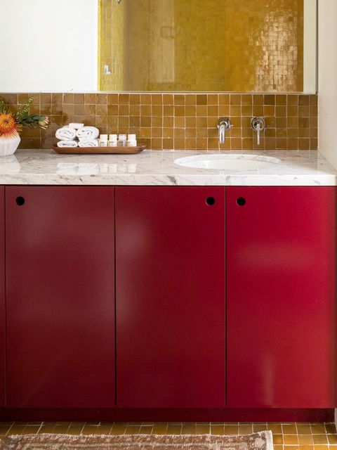 bathroom with red cabinets
