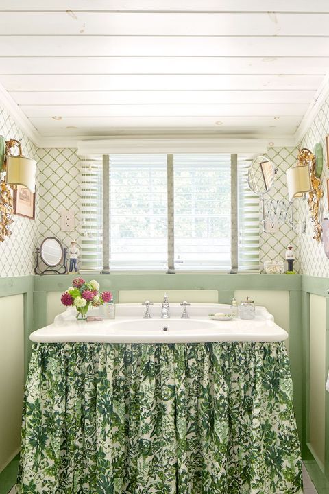 green bathroom with floral vanity skirt