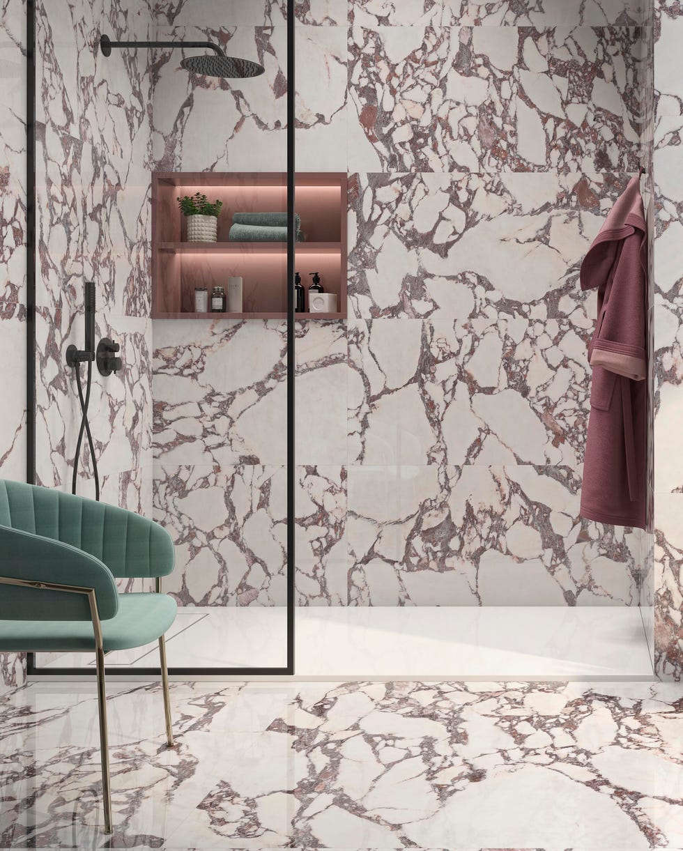 Small bathroom ideas - large format marble tiles a walk in shower with glass screen in a small bathroom with walls and flooring in large format marble tiles