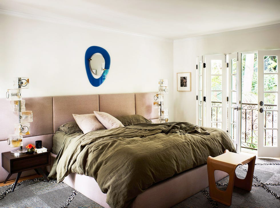 bedroom with linen bedding and leather end stool