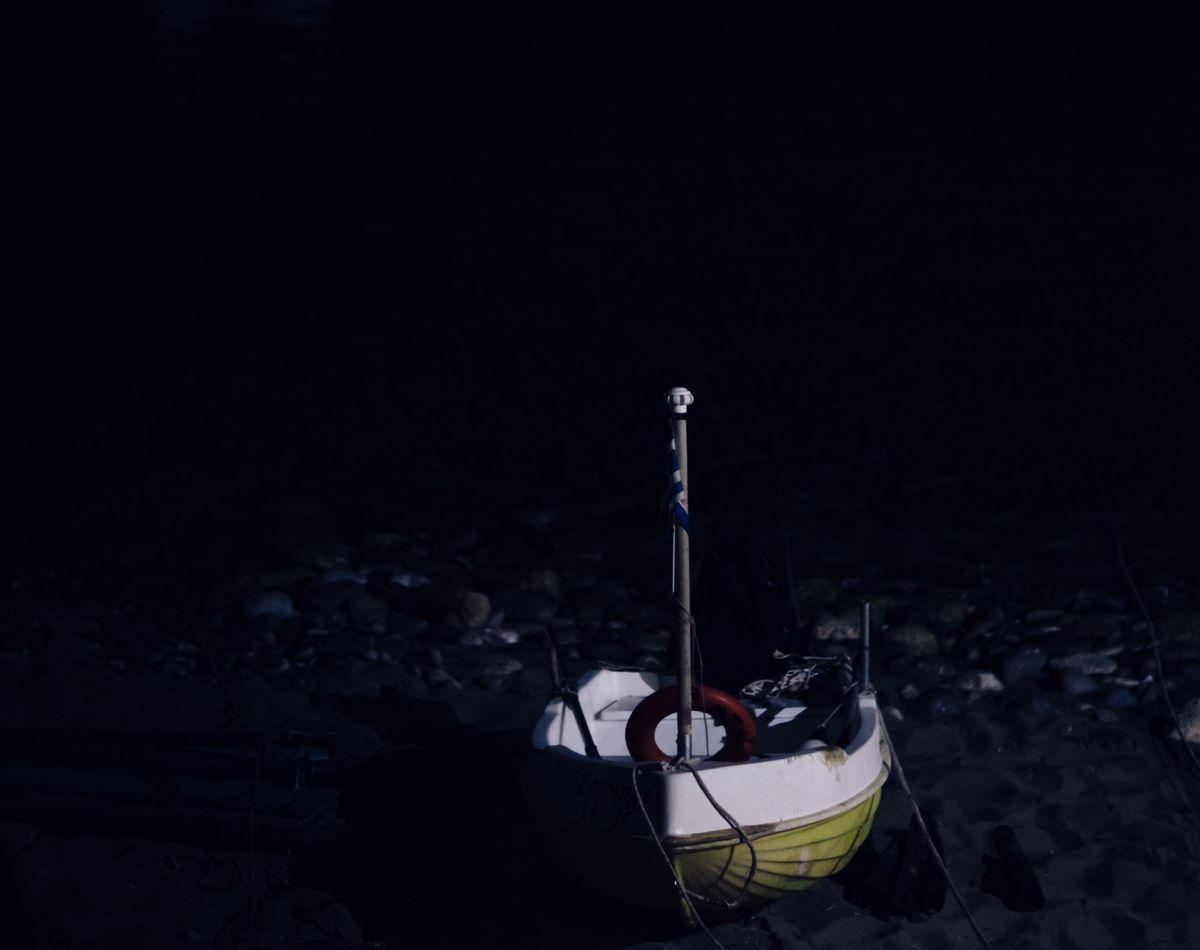 small boat on the beach at night