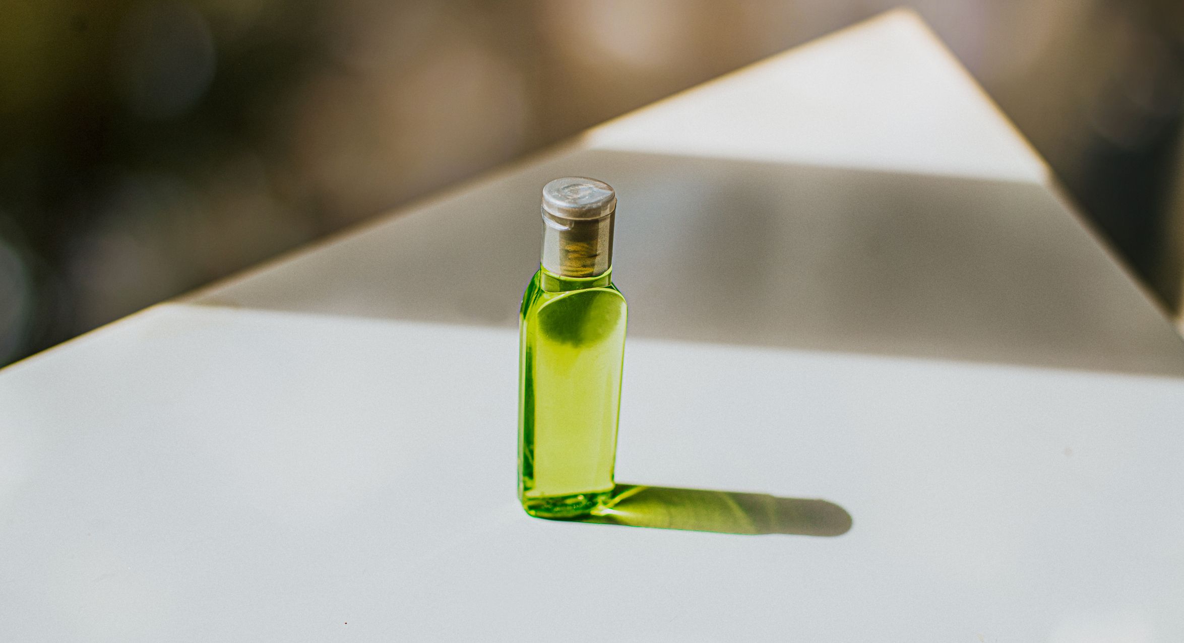 small bottle containing green liquid soap   space for copy