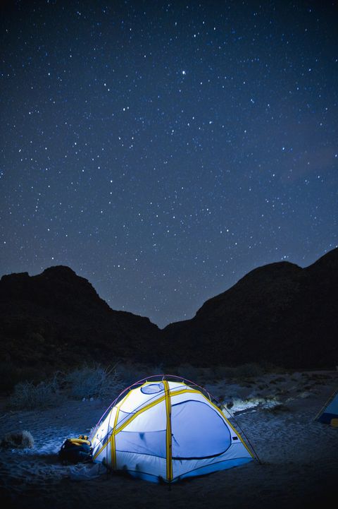 small glowing tent and desert night sky