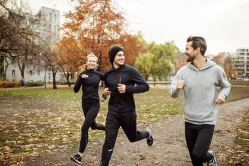 small group of people running in park