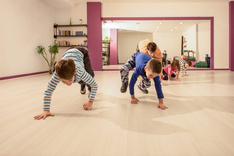 small kids having fun with their coach on sports training
