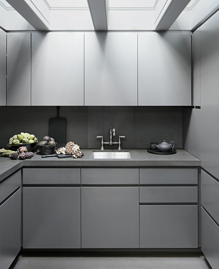 monochromatic gray kitchen with food like artichokes and avocados resting on the counters in bowls