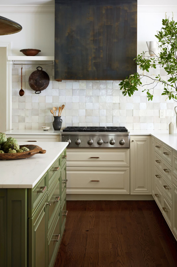 kitchen with white cabinets and some green cabinets on the island