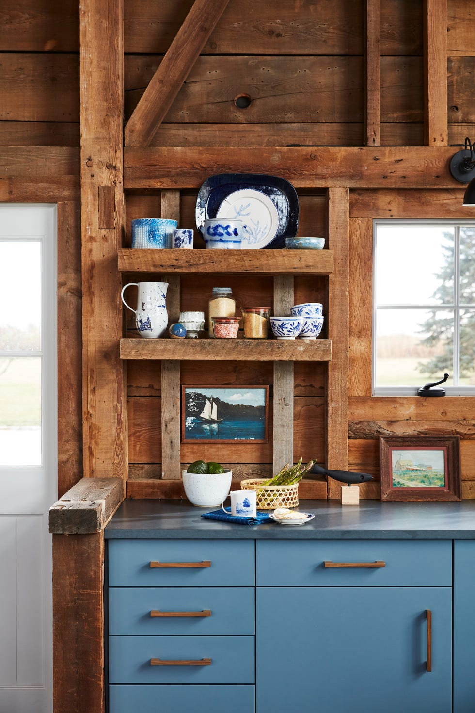 wooden shelves in a rustic blue and brown kitchen
