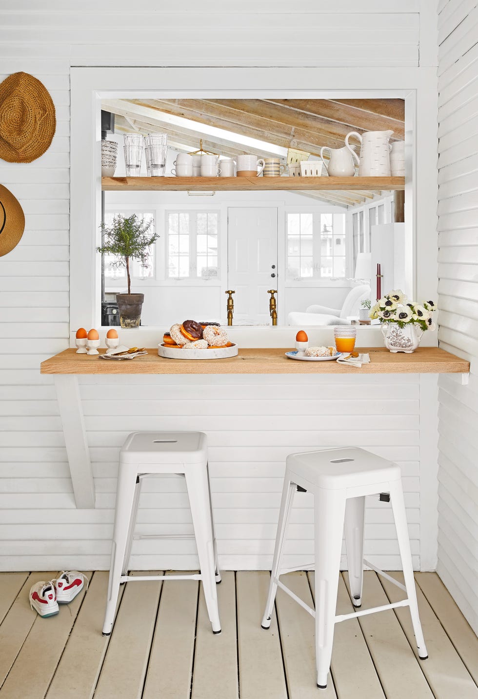 a cozy breakfast area featuring a wooden countertop and two white metal stools