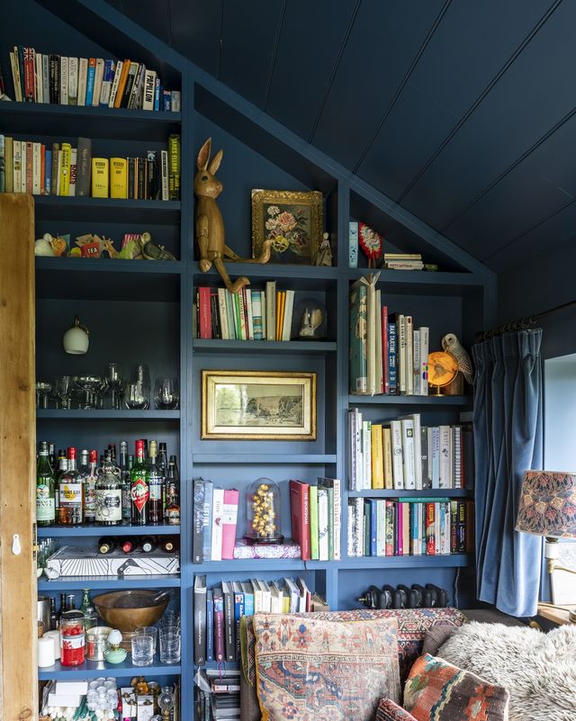 blue built in cabinets with a couch