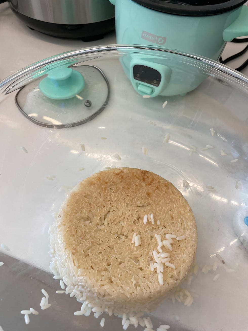 cooked rice formed into a round shape with loose grains around it