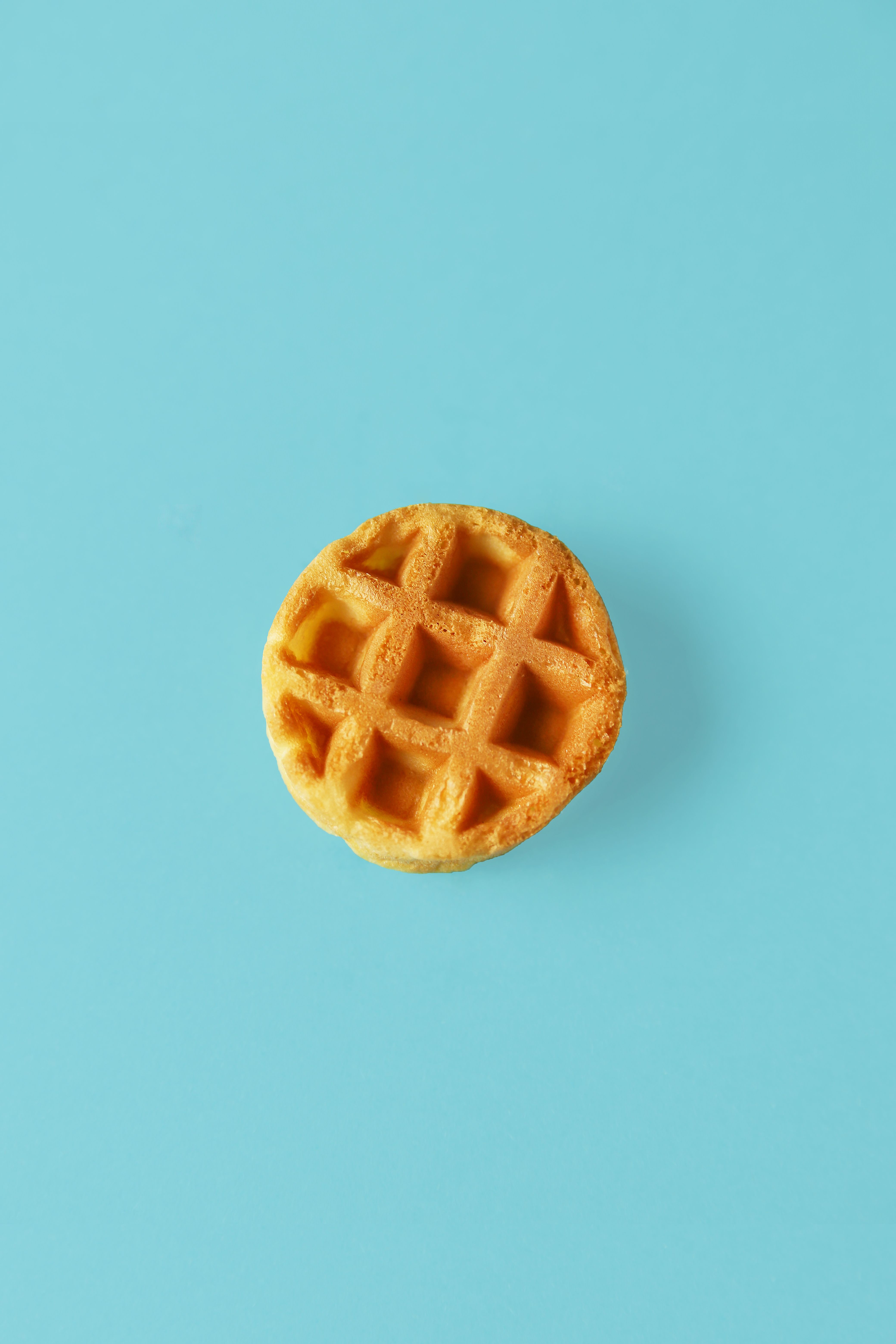 https://hips.hearstapps.com/hmg-prod/images/small-round-belgian-waffle-on-trendy-blue-royalty-free-image-1653068553.jpg