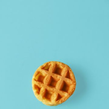 small round belgian waffle on trendy blue background