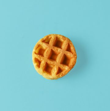 small round belgian waffle on trendy blue background