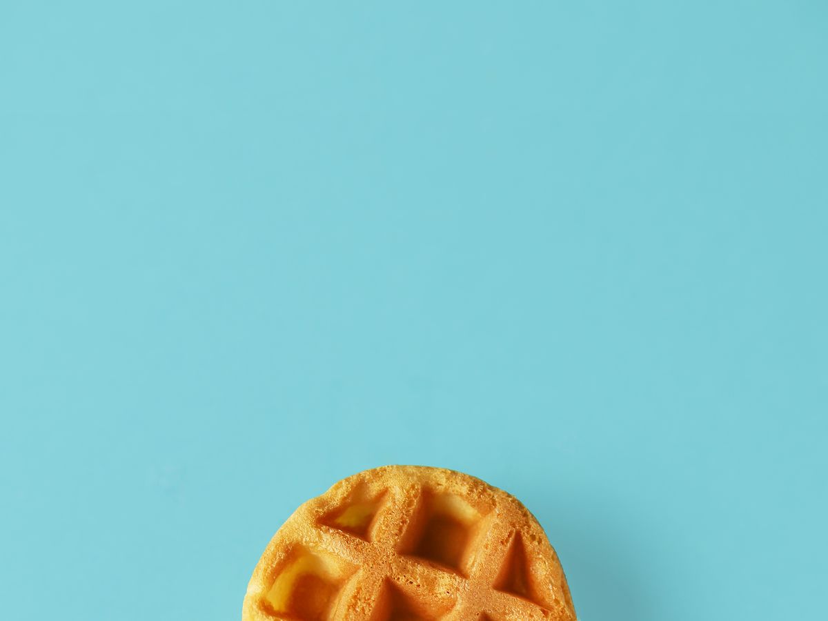 https://hips.hearstapps.com/hmg-prod/images/small-round-belgian-waffle-on-trendy-blue-royalty-free-image-1653068553.jpg?crop=1xw:0.5xh;center,top&resize=1200:*