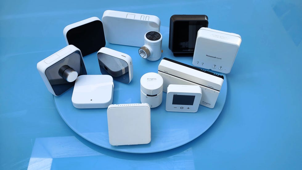 collection of smart thermostat devices arranged on a round blue surface