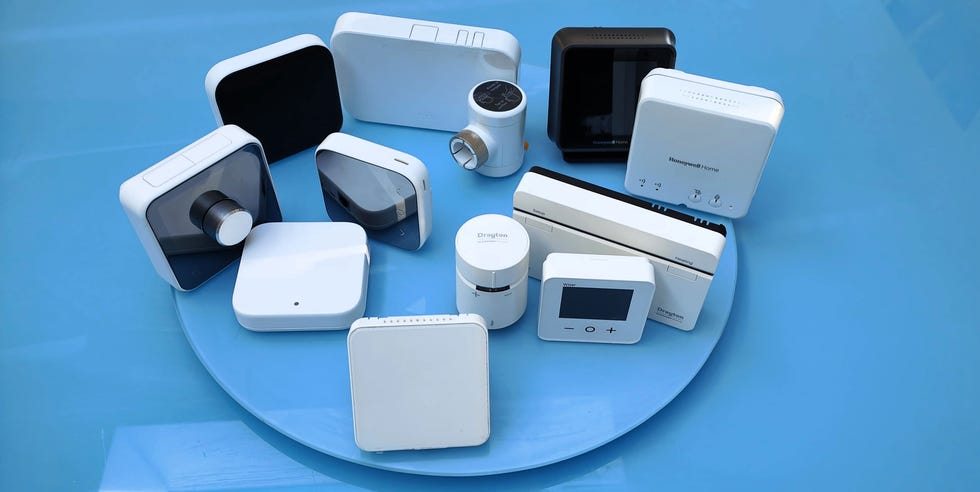 Best smart thermostats collection of smart thermostat devices arranged on a round blue surface