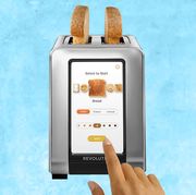 smart toaster with toast in it, light blue background