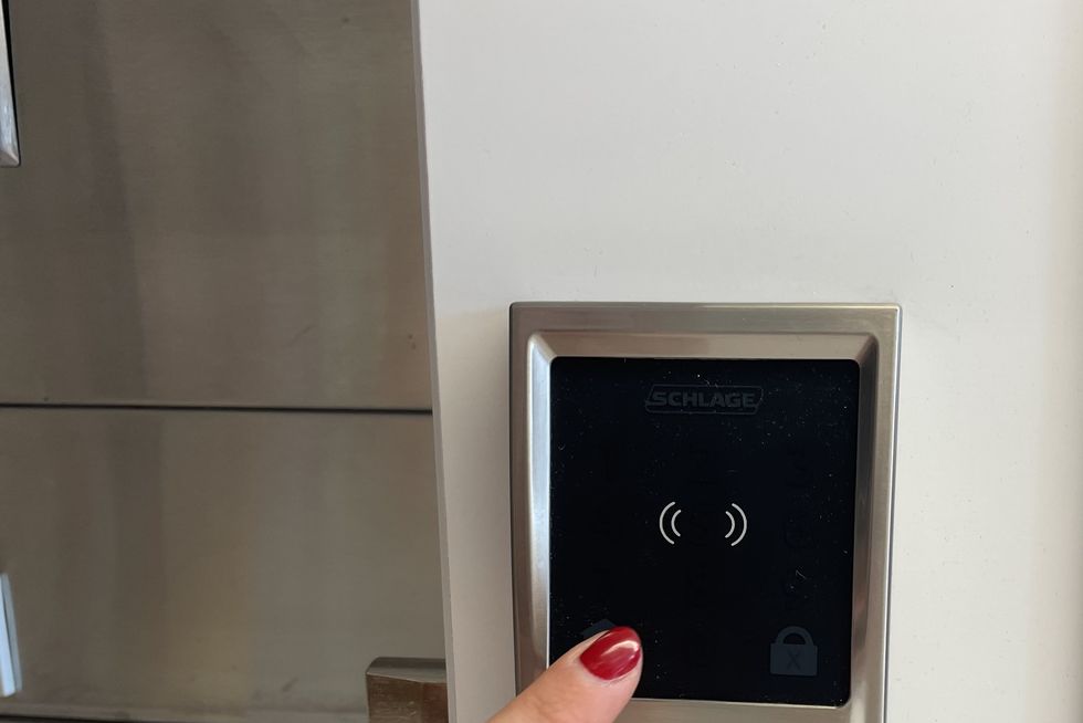 a lab tester evaluates the keypad on a smart lock as part of good housekeeping's smart lock testing