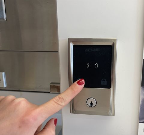 a lab tester evaluates the keypad on a smart lock as part of good housekeeping's smart lock testing