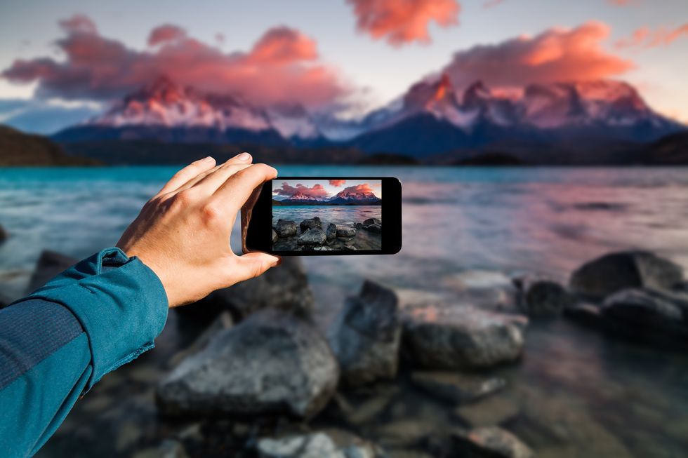 Photographing with smartphone in hand. Travel concept. Torres del Paine, Chili