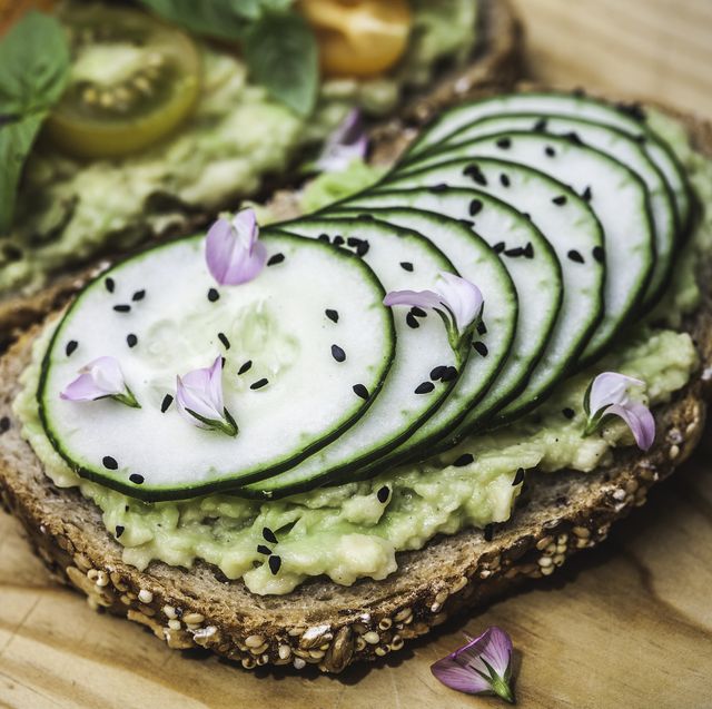 smashed avocado on toast with cucumber, nigella seeds and wildflowers