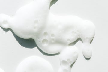 smears of white foam on white background facial cleanser for perfect skin macrophotography in flat lay style