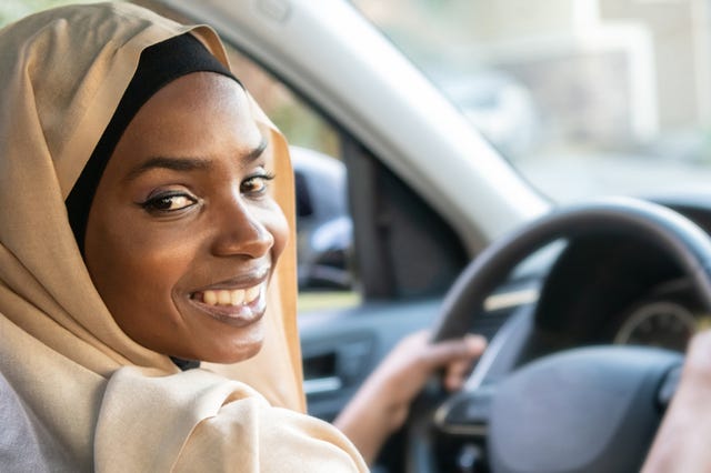 https://hips.hearstapps.com/hmg-prod/images/smiling-black-muslim-woman-driving-her-vehicle-royalty-free-image-1616184880.?crop=0.66649xw:1xh;center,top&resize=640:*