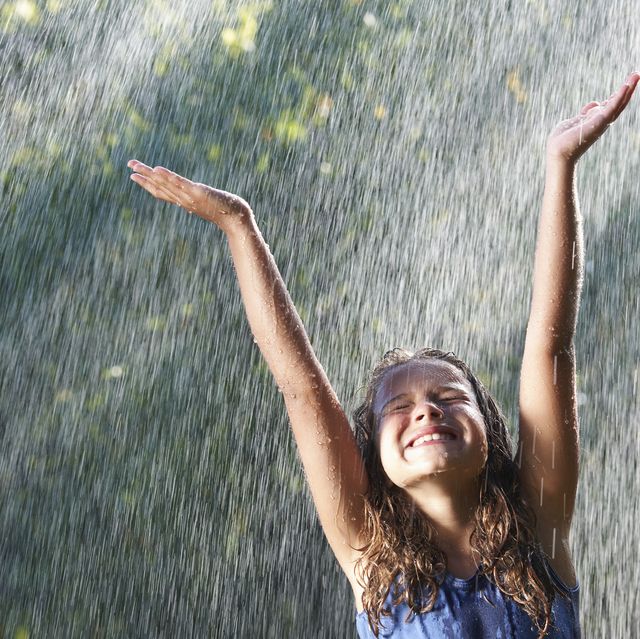 smiling girl playing in rain