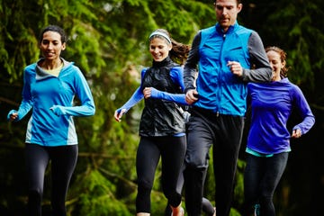 smiling group of friends running together