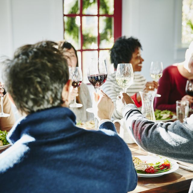 Smiling group of friends toasting during holiday meal together