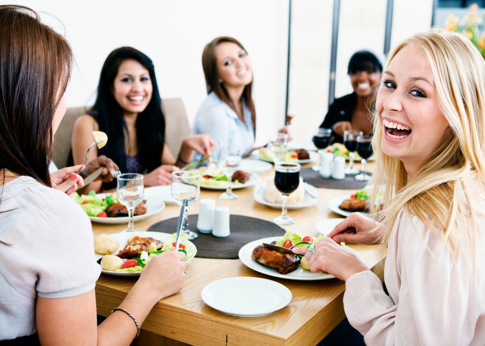 smiling happily, girlfriends get together to enjoy a friendly meal