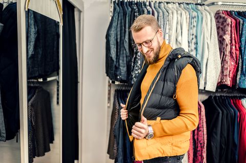 tiktok slang words smiling man buying some clothes at department store