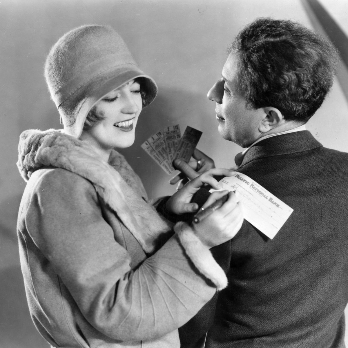 https://hips.hearstapps.com/hmg-prod/images/smiling-marion-davies-signs-a-cheque-on-sid-graumans-news-photo-1595472906.jpg?crop=0.789xw:1.00xh;0.147xw,0&resize=1200:*