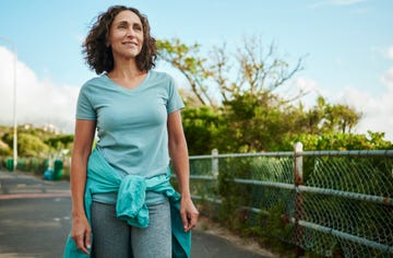 smiling mature woman in sportswear out for a walking in summer