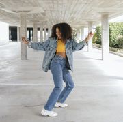 smiling woman dancing in an empty parking