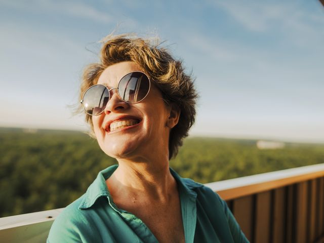 mujer sonriente con gafas de sol