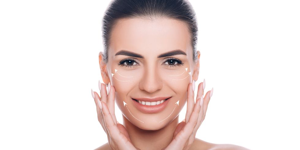 smiling woman with lifting arrows on face concept of skin lifting
