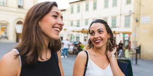 Smiling women in city shopping