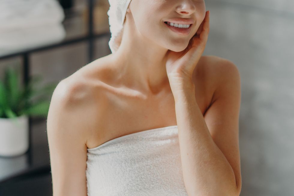 smiling young woman in towel at home