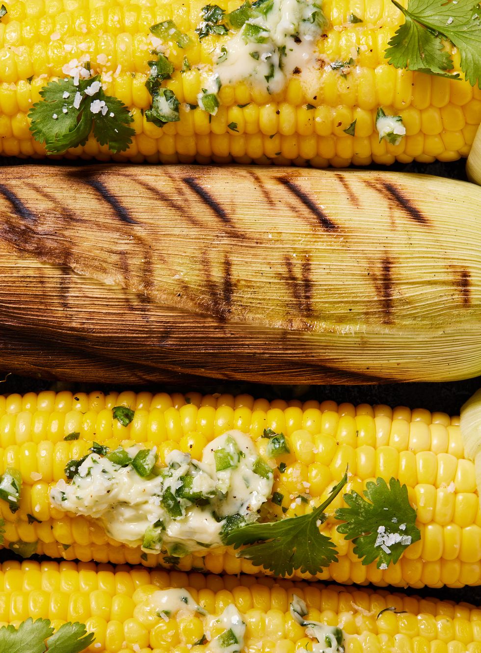 smoked corn on the cob topped with herb butter and cilantro