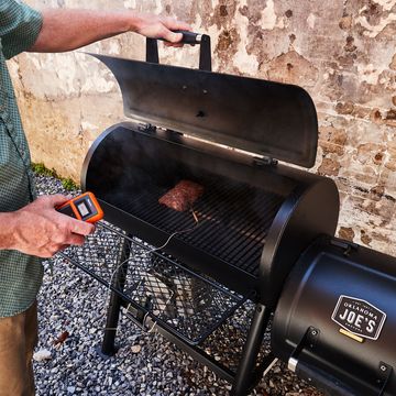 man using thermopro meat thermometer