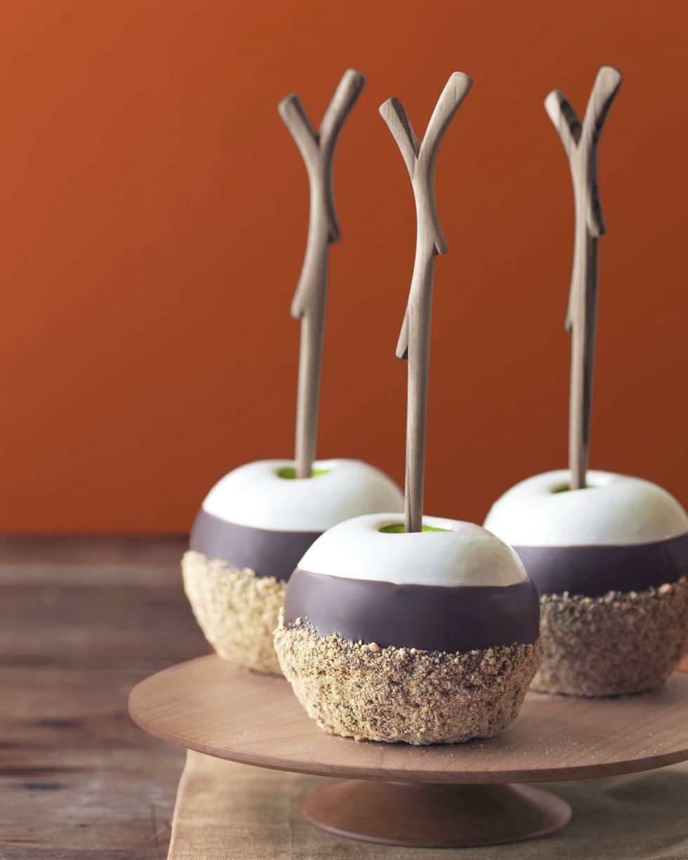 triple dipped smores apples on a wooden cake stand