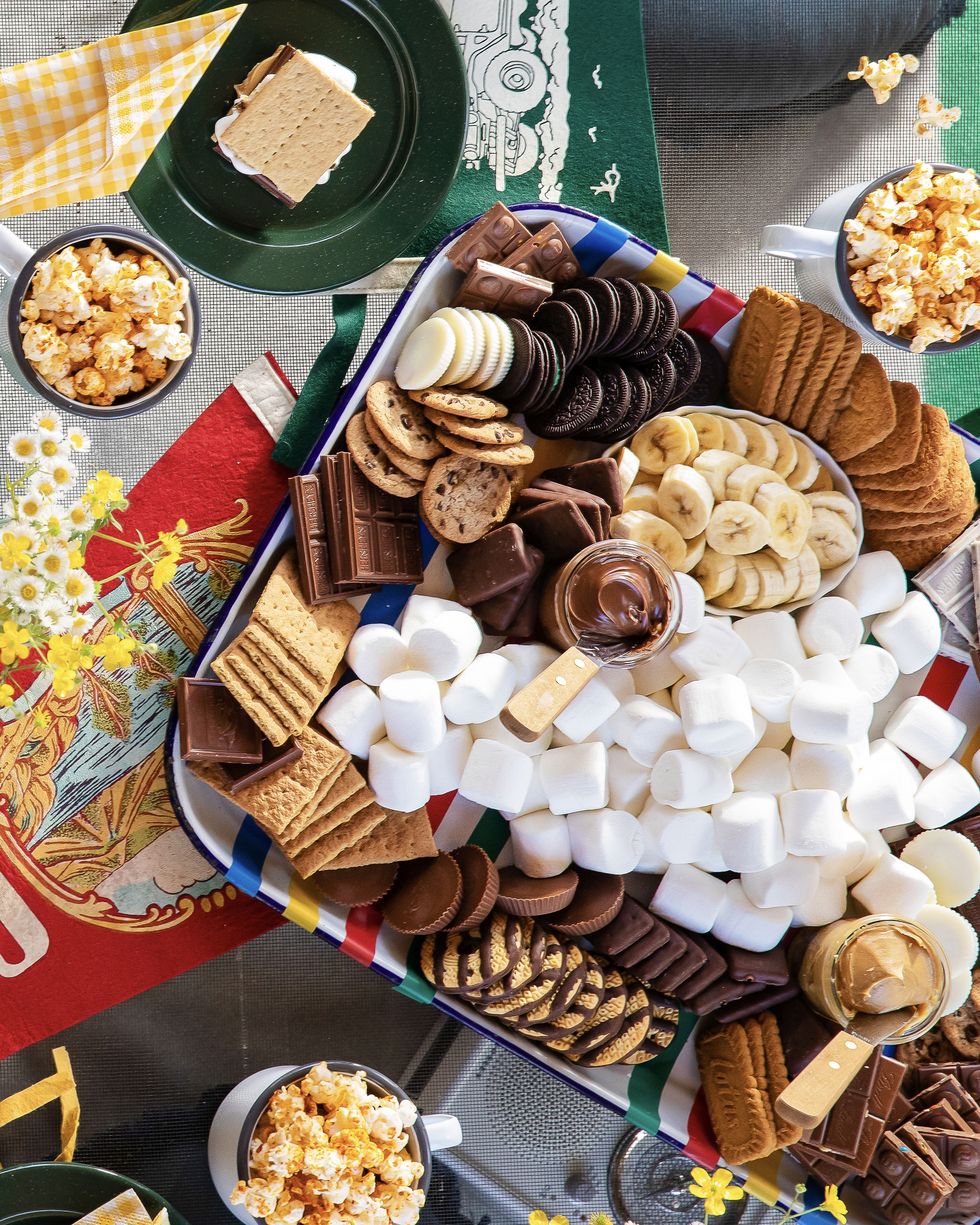 a variety of cookies chocolates candies spreads and marshmallows on a serving tray