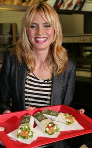 munich, germany   may 29  super model heidi klum poses with three new designed mcdonalds chicken wraps during a press conference at the munich inner city mcdonalds restaurant im tal on may 29, 2008 in munich, germany  photo by johannes simongetty images