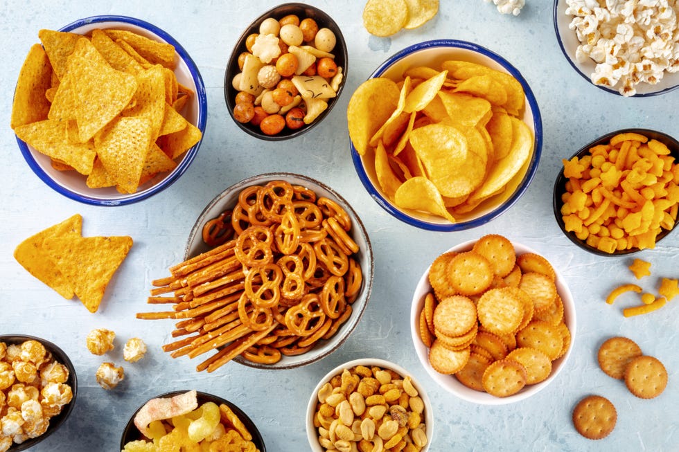 bowls of chips, pretzels, crackers and other snacks