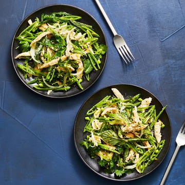 snap pea and chicken salad on a black plate