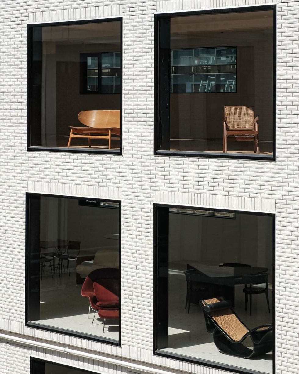 a brick building with windows and chairs