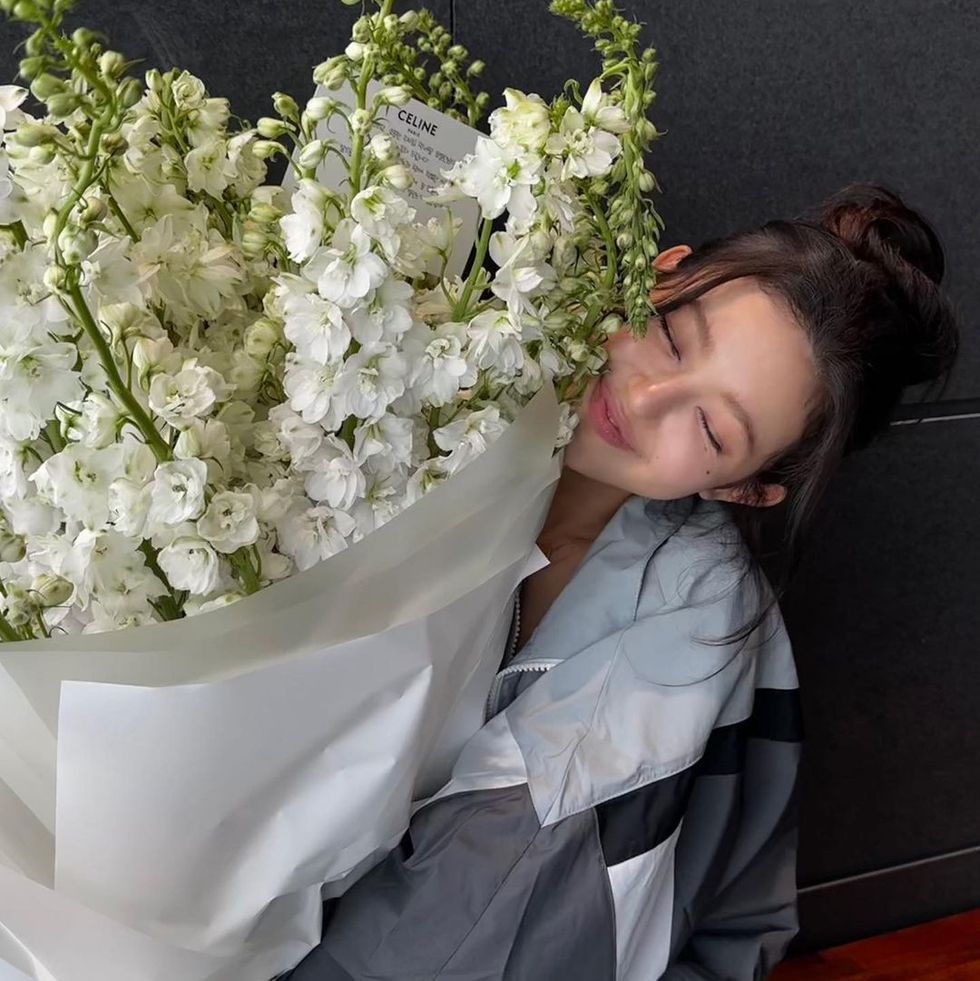 a person lying on a couch with a bouquet of white flowers
