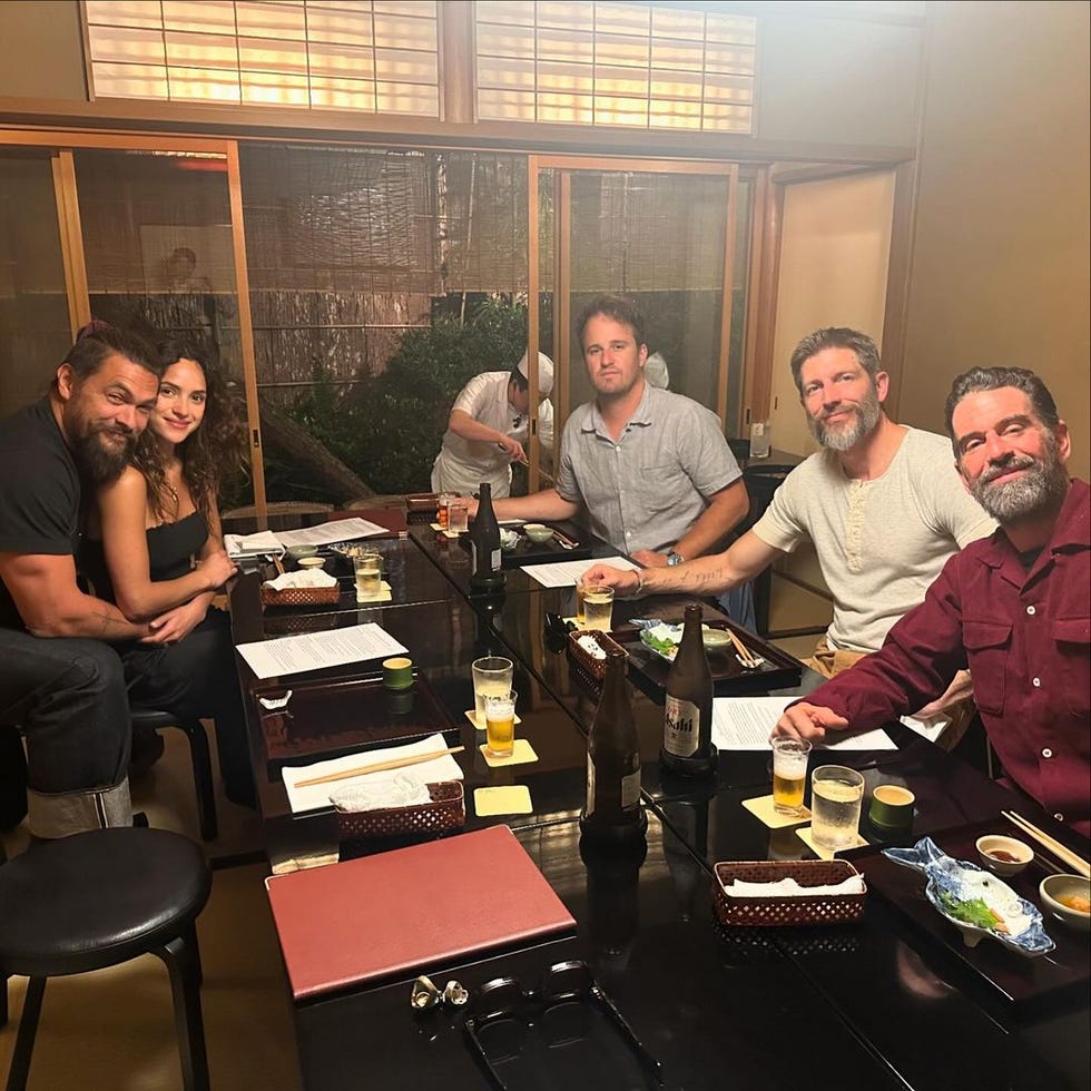 a group of people sitting at a table with drinks